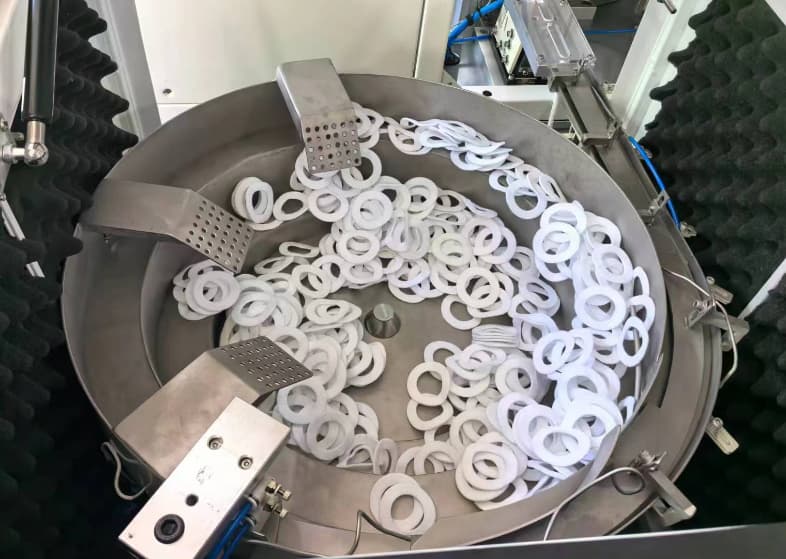 felt vibration bowl Vibratory bowl supplying felt inserts for automated end cap assembly